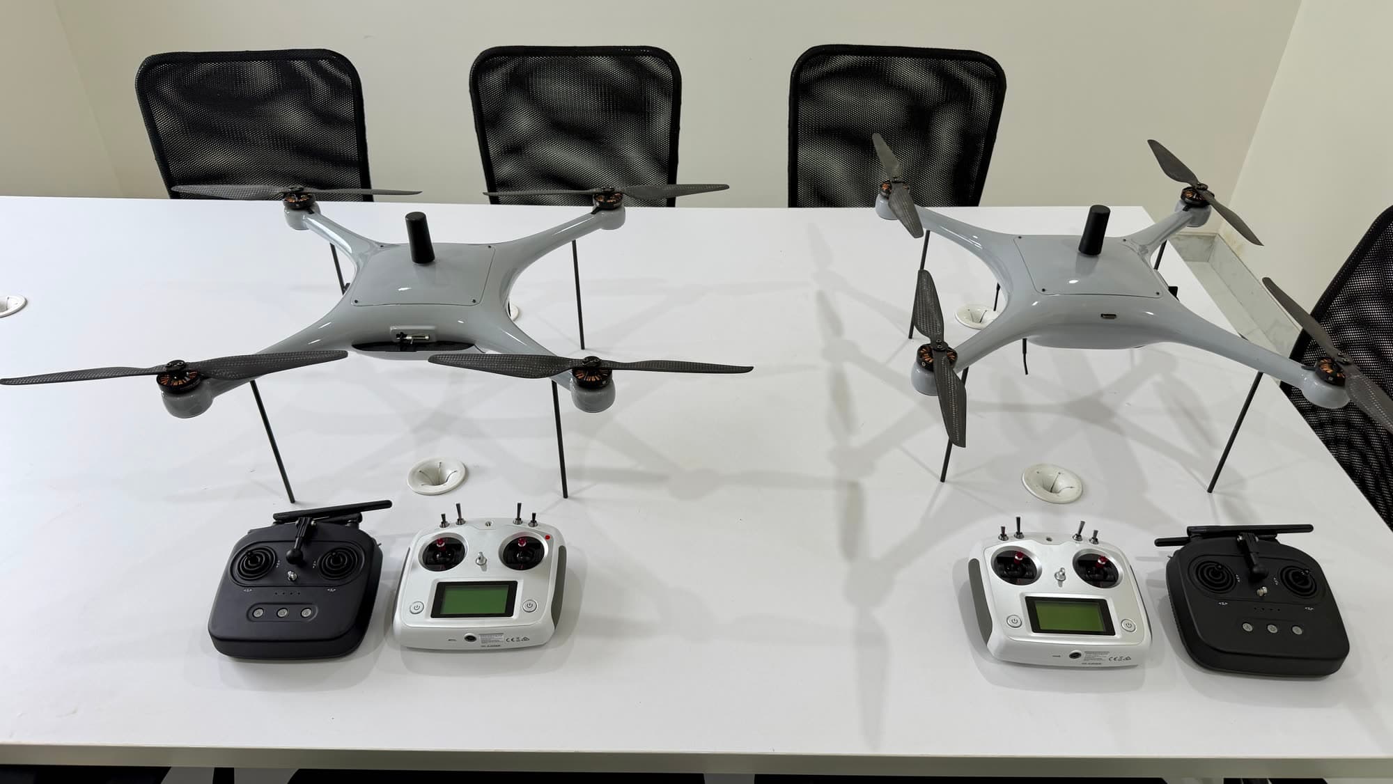 Two training quadcopters with their radio controllers